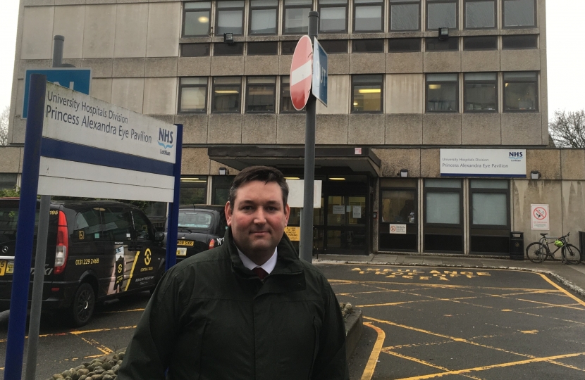 This is a photo of the Princess Alexandra Eye Pavilion with Lothian MSP Miles Briggs outside the front of the building.