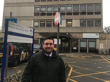 This is a photo of the Princess Alexandra Eye Pavilion with Lothian MSP Miles Briggs outside the front of the building.